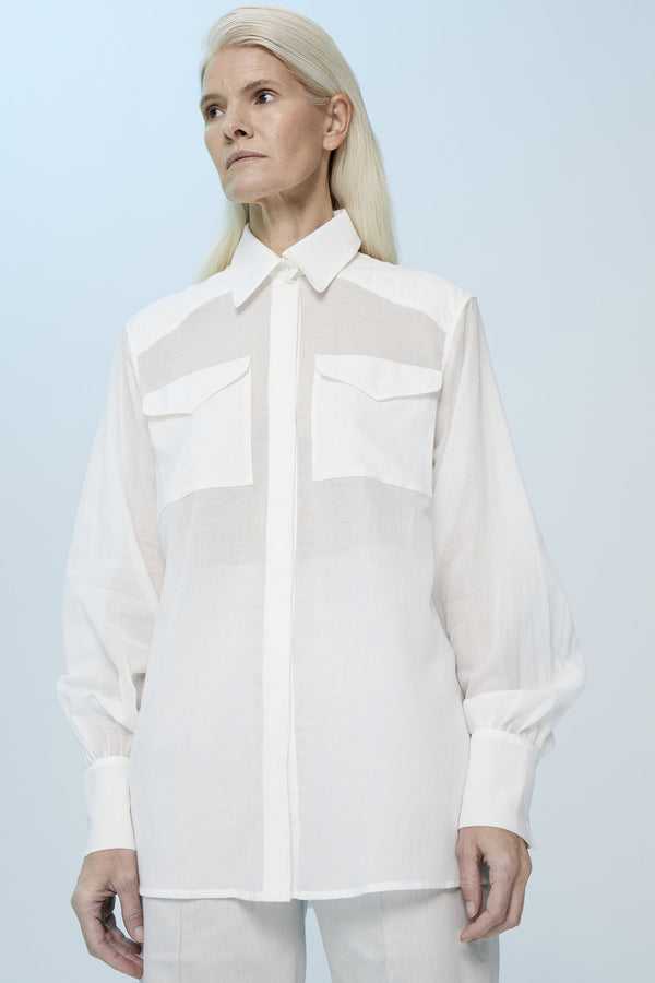 White semi transparent shirt with an oversize fit and chest pockets