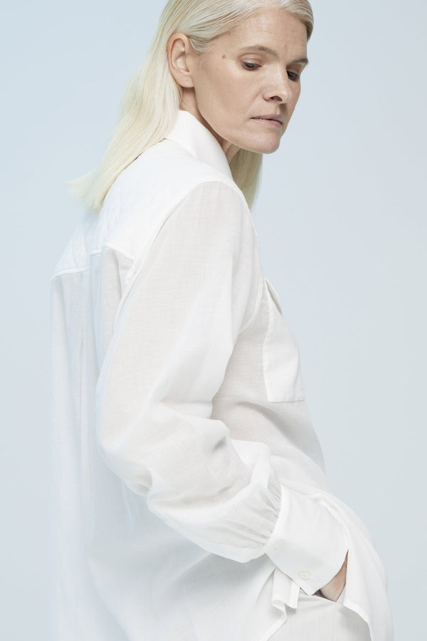 White semi transparent shirt with an oversize fit and chest pockets