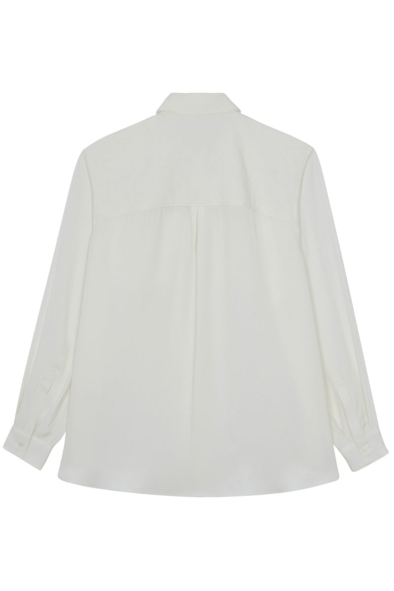 White silk shirt with an oversize fit and chest pockets